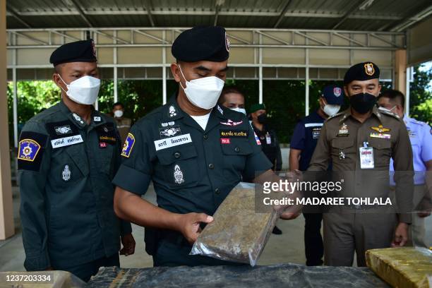 In this photo taken on December 12 a police officer holds a confiscated packet of marijuana, following the interception of a smuggling operation of...