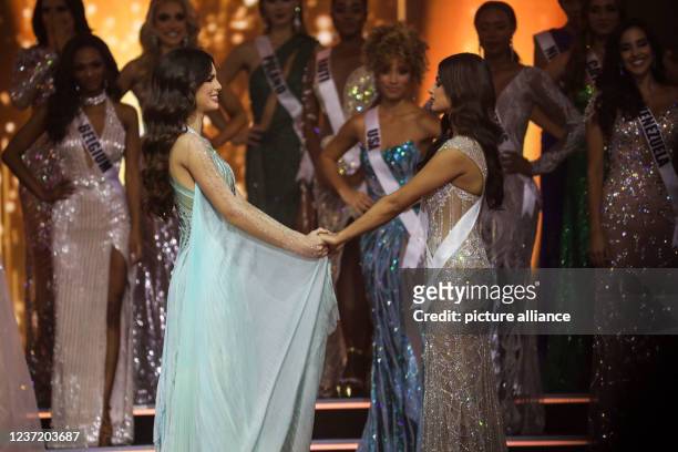 December 2021, Israel, Eilat: Miss Paraguay Nadia Ferreira , and Miss India, Harnaaz Sandhu react while holding hands ahead of announcing the winner...