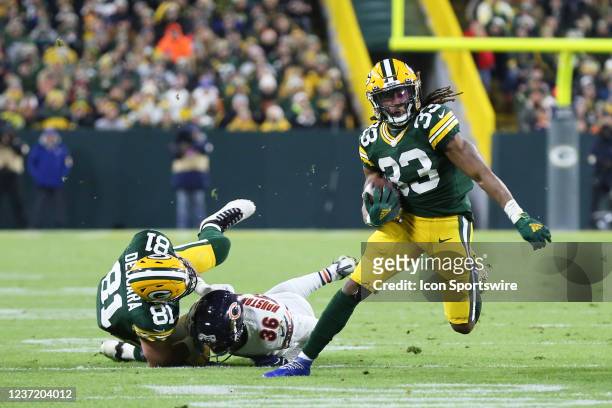 Green Bay Packers running back Aaron Jones breaks thru a hole during a game between the Green Bay Packers and the Chicago Bears at Lambeau Field on...