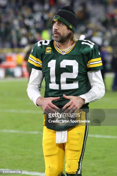 Green Bay Packers quarterback Aaron Rodgers rewards fans with his signature championship belt move during a game between the Green Bay Packers and...