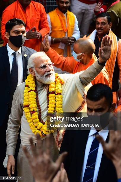 Indian Prime Minister Narendra Modi gestures as he arrives to inaugurate the Kashi Vishwanath Dham Corridor, in Varanasi on December 13, 2021.