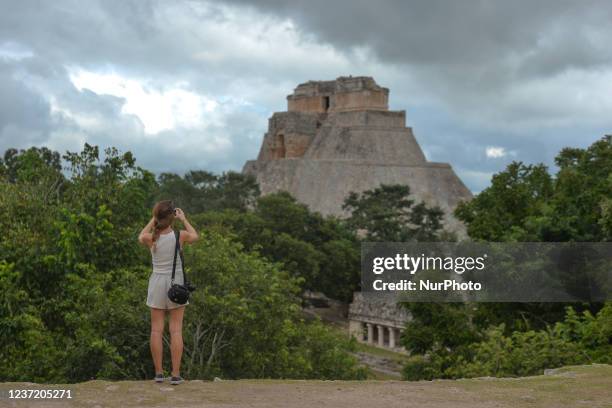 Visitor takes picture of the Pyramid of the Magician inside the ancient Mayan city of Uxmal. On Thursday, December 02 in Uxmal, Yucatan, Mexico.