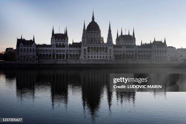 Photograph taken on December 13, 2021 shows the Hungarian Parliament Building and its reflexion on the Danube river, in Budapest.