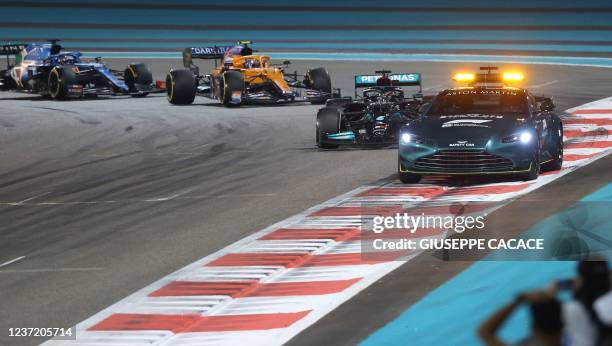 Mercedes' British driver Lewis Hamilton drives behind the safety car at the Yas Marina Circuit during the Abu Dhabi Formula One Grand Prix on...