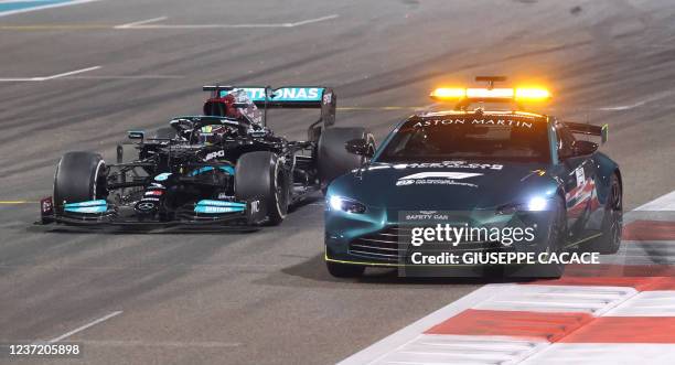 Mercedes' British driver Lewis Hamilton drives behind the safety car at the Yas Marina Circuit during the Abu Dhabi Formula One Grand Prix on...