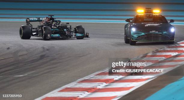 Mercedes' British driver Lewis Hamilton drives behind the safety car at the Yas Marina Circuit during the Abu Dhabi Formula One Grand Prix on...