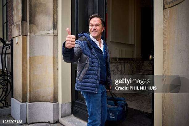 Outgoing Dutch Prime Minister and VVD-leader Mark Rutte gestures upon his arrival to attend a progress meeting with informateur Wouter Koolmees, the...