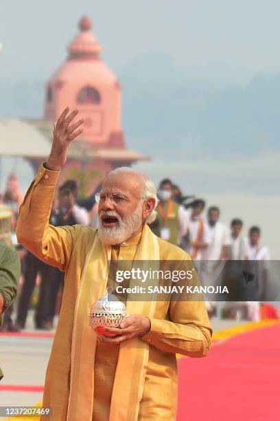 Indian Prime Minister Narendra Modi carries holy water of Ganges to offer prayers as he arrives to inaugurate Kashi Vishwanath Dham Corridor, in...