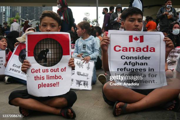 Afghan refugees hold a long march from the US embassy to Canada embassy as a protest in Jakarta, Indonesia on December 12, 2021. They urged the US...