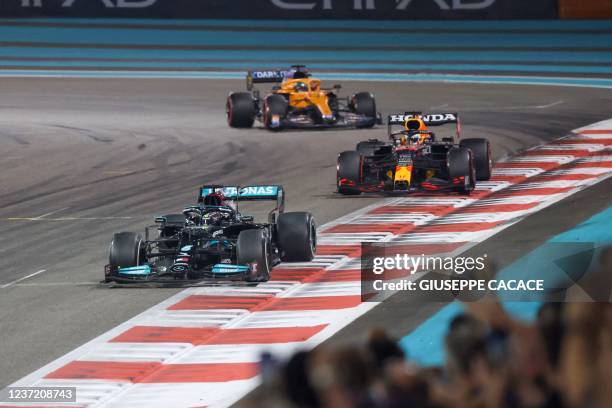 Mercedes' British driver Lewis Hamilton 2021 is followed by Red Bull's Dutch driver Max Verstappen at the Yas Marina Circuit during the Abu Dhabi...