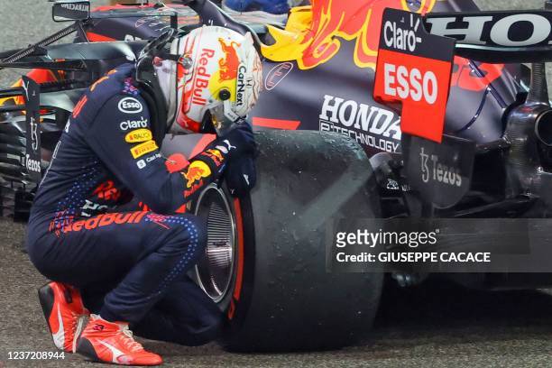 Formula One World Champion Red Bull's Dutch driver Max Verstappen celebrates in the parc ferme of the Yas Marina Circuit after winning the Abu Dhabi...