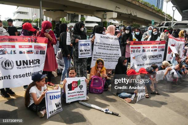 Afghan refugees hold a long march from the US embassy to Canada embassy as a protest in Jakarta, Indonesia on December 12, 2021. They urged the US...