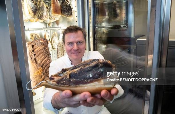 Belgium's Chef Christophe Hardiquest of Bon Bon restaurant in Woluwe-Saint-Pierre poses with ham in Brussels, as part of the digital presentation of...