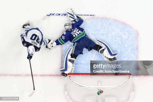 Vancouver Canucks Goalie Thatcher Demko makes a final shoot-out save against Winnipeg Jets Center Pierre-Luc Dubois to take a 4-3 victory during...