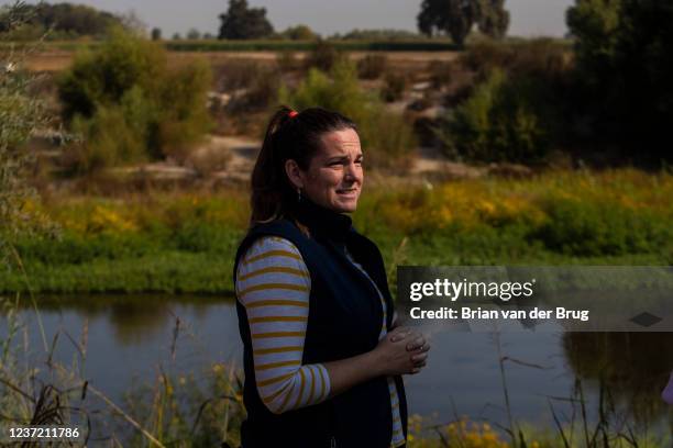 September 21, 2021: River Partners president Julie Rentner stands along the bank of the Tuolumne River near a restored floodplain and riparian...