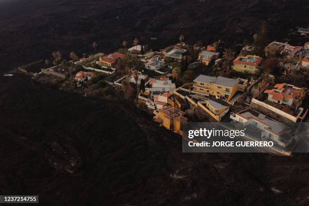 This aerial picture shows houses covered with lava following the eruption of the Cumbre Vieja volcano, in Las Norias, on the Canary Island of La...