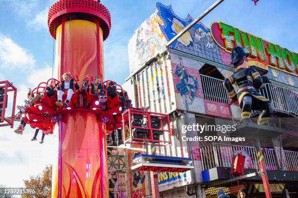 Children seen enjoying one of the amusement park rides in the Winter Wonderland. Winter Wonderland has returned to Hyde Park in London after it was...