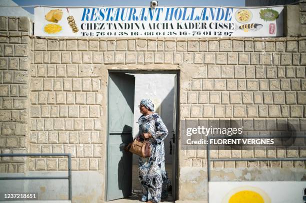 Aicha Tandina Kader Cisse leaves her restaurant "Le Hollande" on Timbuktu, on December 7, 2021. - France's anti-jihadist military force in the Sahel...