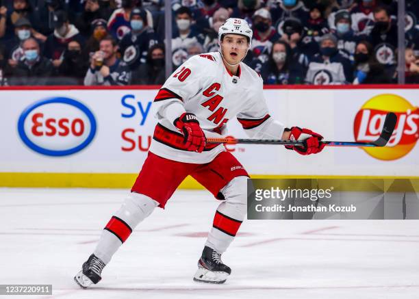 Sebastian Aho of the Carolina Hurricanes keeps an eye on the play during first period action against the Winnipeg Jets at Canada Life Centre on...