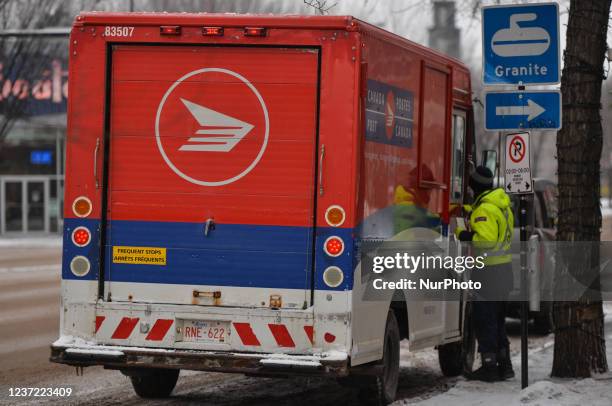 Canada Post truck. On Whyte Avenue in Edmonton. Monday, December 13 in Edmonton, Alberta, Canada.