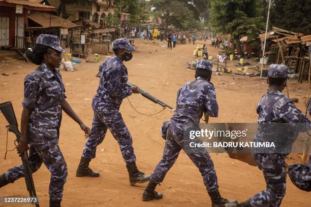 Police officers secure the area of a planned final campaign of Harriet Nakwedde from the National Unity Platform opposition party for the by-election...