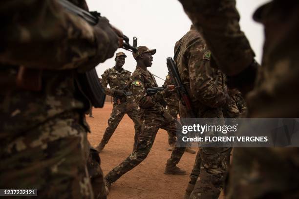 Malian soldiers dance after the handover ceremony of the Barkhane military base by the French army in Timbuktu, on December 14, 2021.