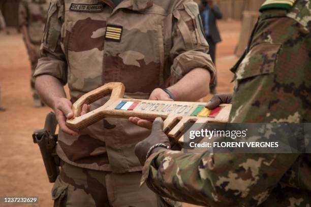 French colonel Faivre hands over the symbolic key of Camp Barkhane to the Malian colonel during the handover ceremony of the Barkhane military base...