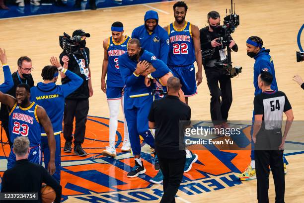 Stephen Curry of the Golden State Warriors hugs Andre Iguodala of the Golden State Warriors after passing Ray Allen for most three pointers made in...