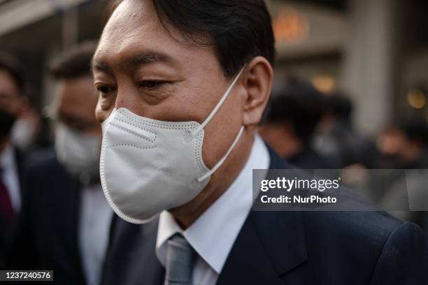 Yoon Suk-Yeol, the presidential candidate of the opposition People Power Party, walks out after a press conference on December 15 2021 in Seoul,...