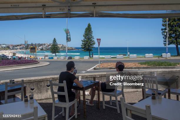 Customers sit outside of a cafe at Bondi Beach in Sydney, Australia, on Wednesday, Dec. 15, 2021. Australian household sentiment declined this month...