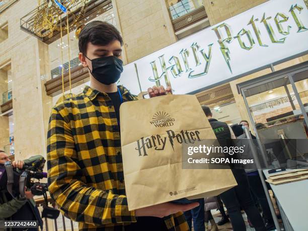 Harry Potter fan holds a branded shopping bag at the Harry Potter pop-up shop at Central Children's Store in Lubyanka. Harry Potter pop-up shop opens...