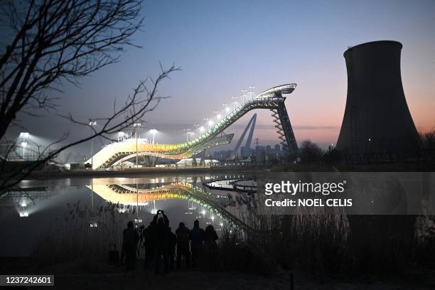 People take photos of the Shougang Big Air venue, which will host the big air freestyle skiing and snowboarding competitions at the Beijing 2022...