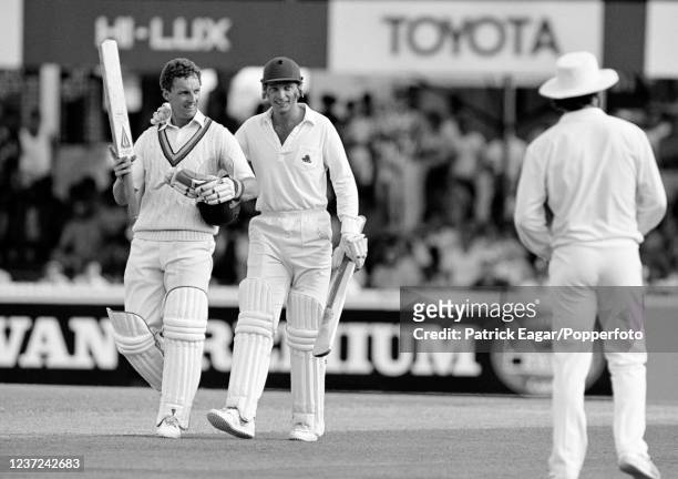 Jack Richards of England is congratulated on his maiden Test century by teammate David Gower during his innings of 133 in the 2nd Test match between...