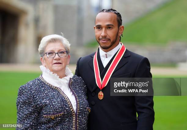 Sir Lewis Hamilton with his mother Carmen Lockhart after he was made a Knight Bachelor by the Prince of Wales during a investiture ceremony at...