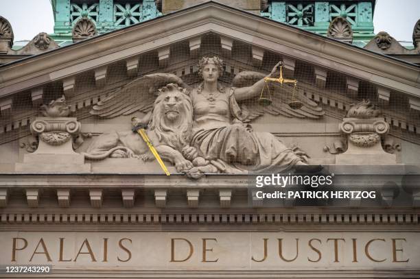 This photograph taken on December 15 shows a view of the emblem of justice on the front of the courthouse, as protestors take part in a demonstration...