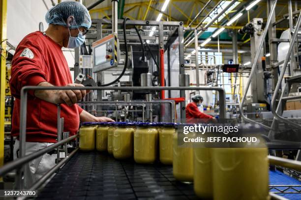 Employees work at the Reine de Dijon mustard factory, in Fleurey sur Ouche, eastern France, on December 14, 2021 .