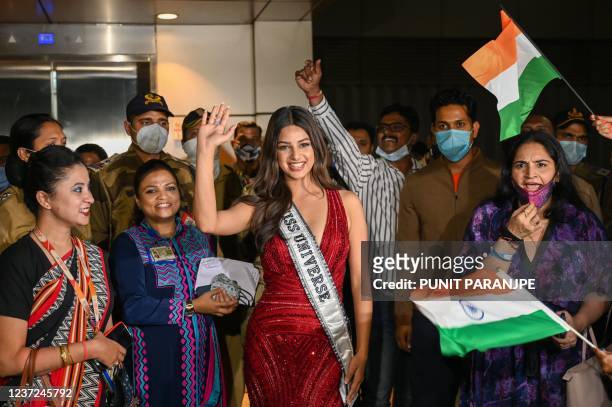Miss Universe 2021 Harnaaz Sandhu , winner of the 70th Miss Universe beauty pageant, gestures as she poses for pictures after arriving at the...