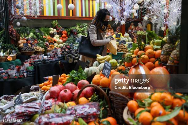 Customer shops for fresh produce at Borough Market in London, U.K., on Wednesday, Dec. 15, 2021. U.K. Inflation surged to its highest level in more...