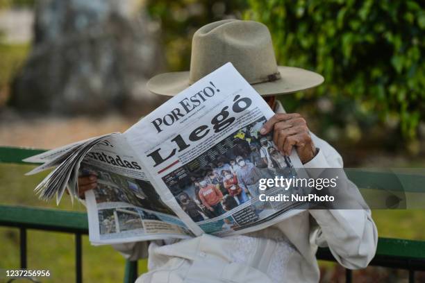 Local man reads 'Por Esto!' , a daily Mexican newspaper headquartered in Mérida that covers the Mexican states of Yucatán, Campeche, and Quintana Roo...