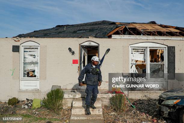 Cletus Smith, a member of Tennessee Task Force 1, finishes searching through a home in Bowling Green, Kentucky on December 15 five days after...