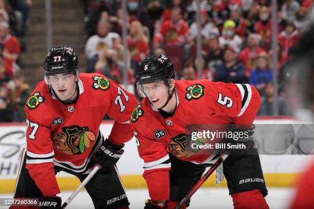 Kirby Dach and Connor Murphy of the Chicago Blackhawks wait for the face-off against the Washington Capitals at United Center on December 15, 2021 in...