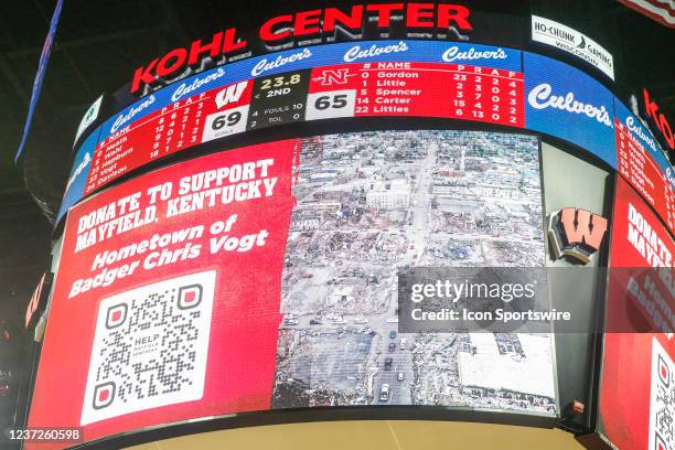 Near the end of the game the Kohl Center scoreboard shows a QR-code link to the Go Fund Me site of Wisconsin center Chris Vogt raising funds for...