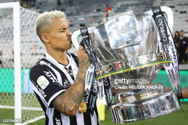 Atletico Mineiro's Allan kisses the trophy as he celebrates after his team won the 2021 Brazil Cup second leg final football match against Athletico...