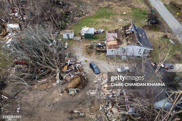This aerial view shows a fallen tree on the ground near the destroyed house of the pastor of Cayce United Methodist Church in Cayce, Kentucky, on...