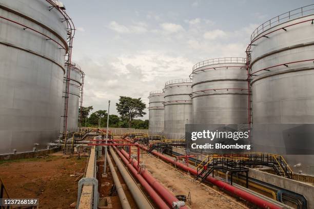 Pipework runs alongside fuel storage tanks at the Mahathi Infra Uganda Ltd. Oil logistics complex on the shore of Lake Victoria in Entebbe, outside...