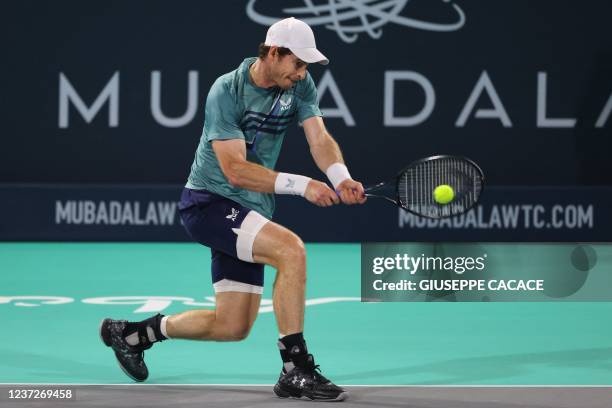 Britain's Andy Murray returns the ball to Britain's Dan Evans during their quarter-final match in the Mubadala World Tennis Championship in the Gulf...