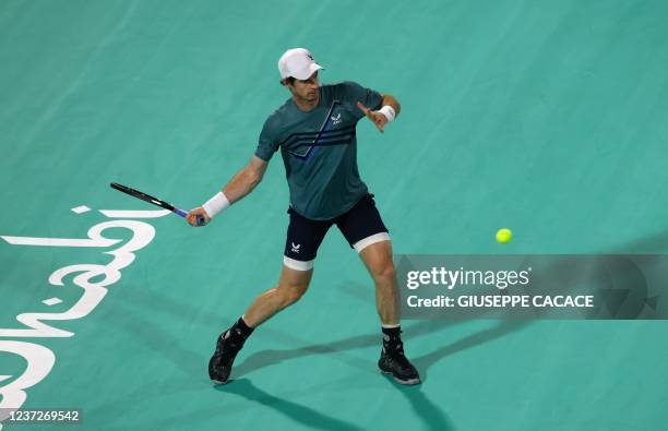 Britain's Andy Murray returns the ball to Britain's Dan Evans during their quarter-final match in the Mubadala World Tennis Championship in the Gulf...