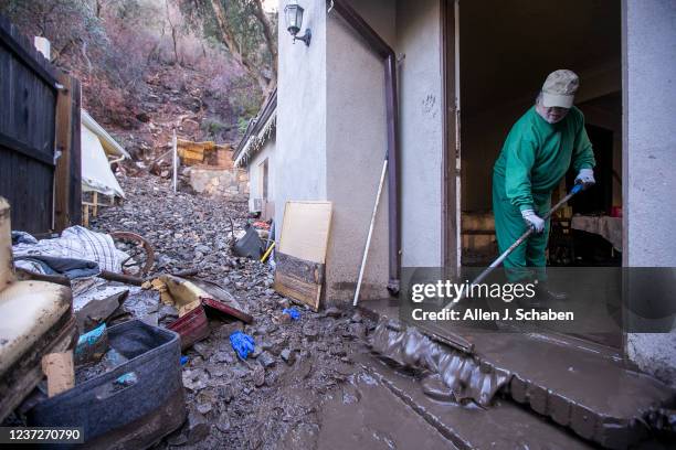 Silverado Canyon, CA Dennis Landry removes mud from his son, Ginos guest house that had several feet of mud inside after a winter storm brought mud...