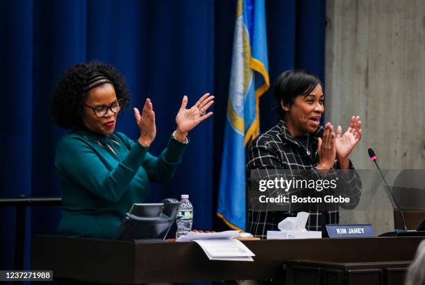 Boston, MA City Council President Kim Janey, left, and Councilor Andrea Campbell clap during their final City Council Meeting at Boston City Hall on...