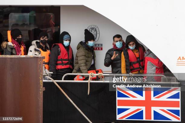 Asylum seekers arriving into Dover docks on board BF Hurricane, a large Border Force boat after being rescued in the English Channel while crossing...